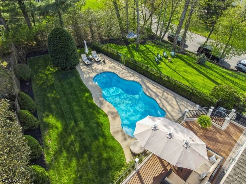 Set on nearly half an acre in the coveted Wickham Woods section of Chatham Township, this custom built home blends timeless elegance w modern updates exceptional indoor outdoor living.