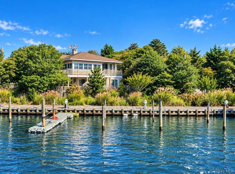 Experience waterfront luxury at 76 Bay Walk, an exceptional, completely renovated home situated directly on the harbor in the heart of Fire Island Pines.