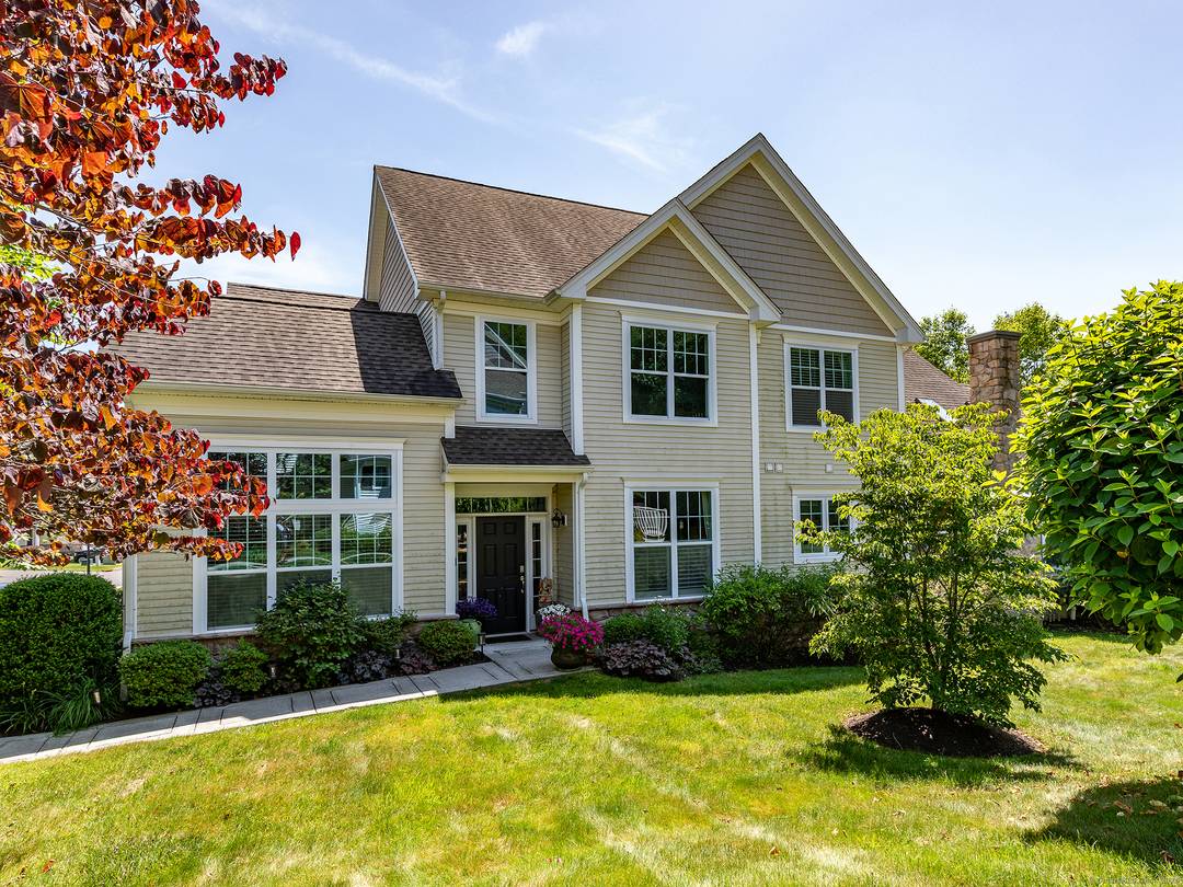 Walls of windows ! Spectacular, light filled end unit at an award winning townhome community in Middlebury.