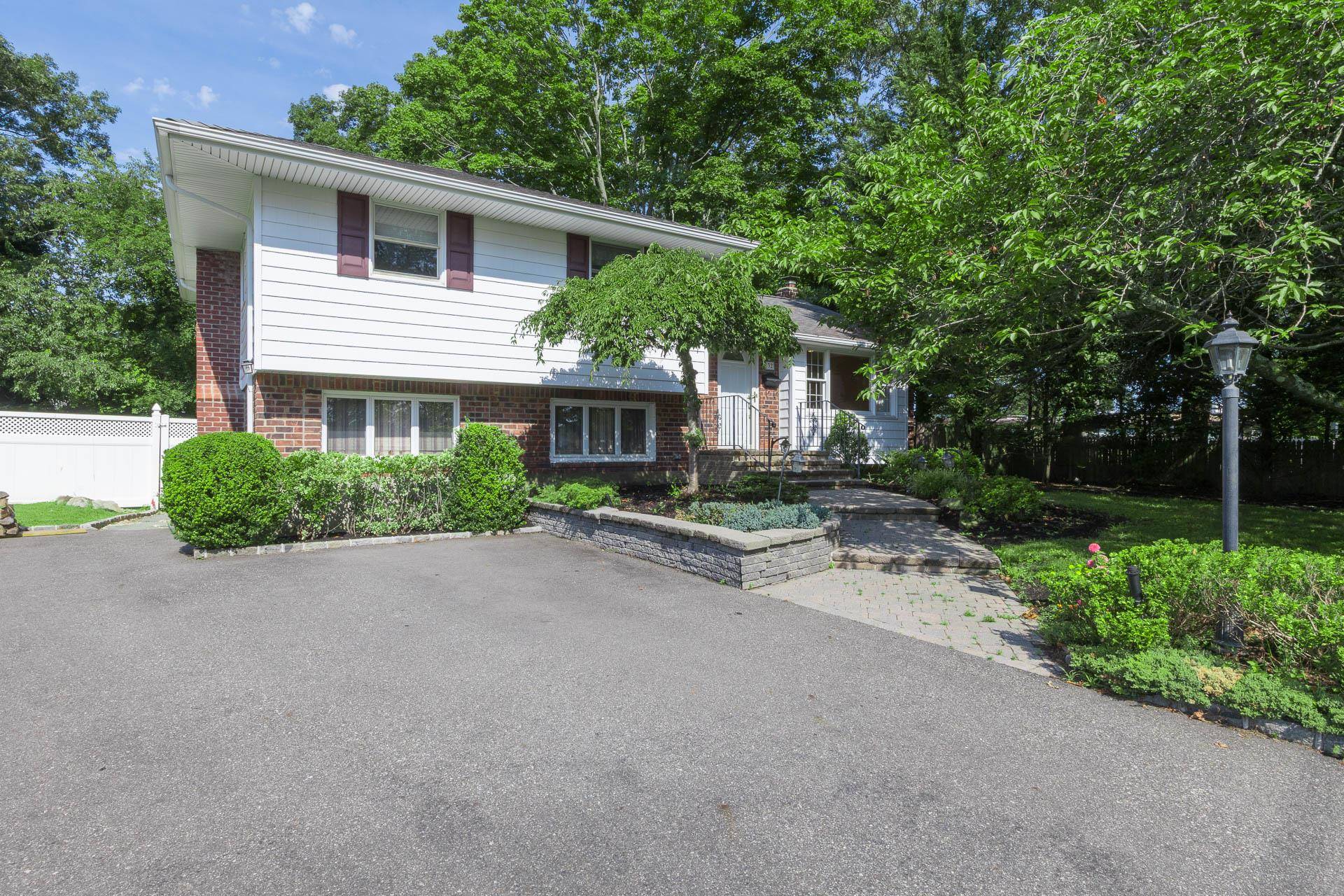 This charming split level home in the Commack School District offers comfort, style, and space for everyone.