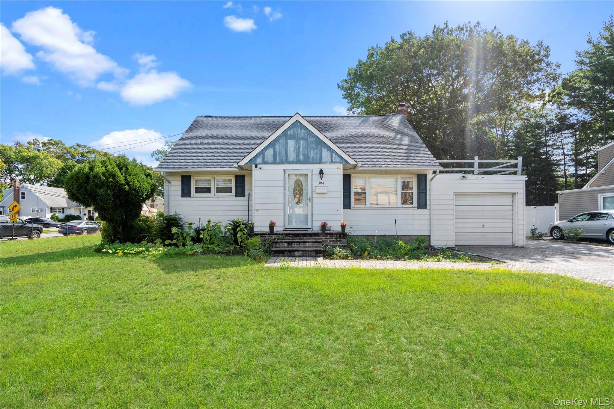 Welcome to 304 Unqua Road, a beautifully maintained 3 bedroom, 2 full bath Cape style home offering comfort, versatility, and convenience.