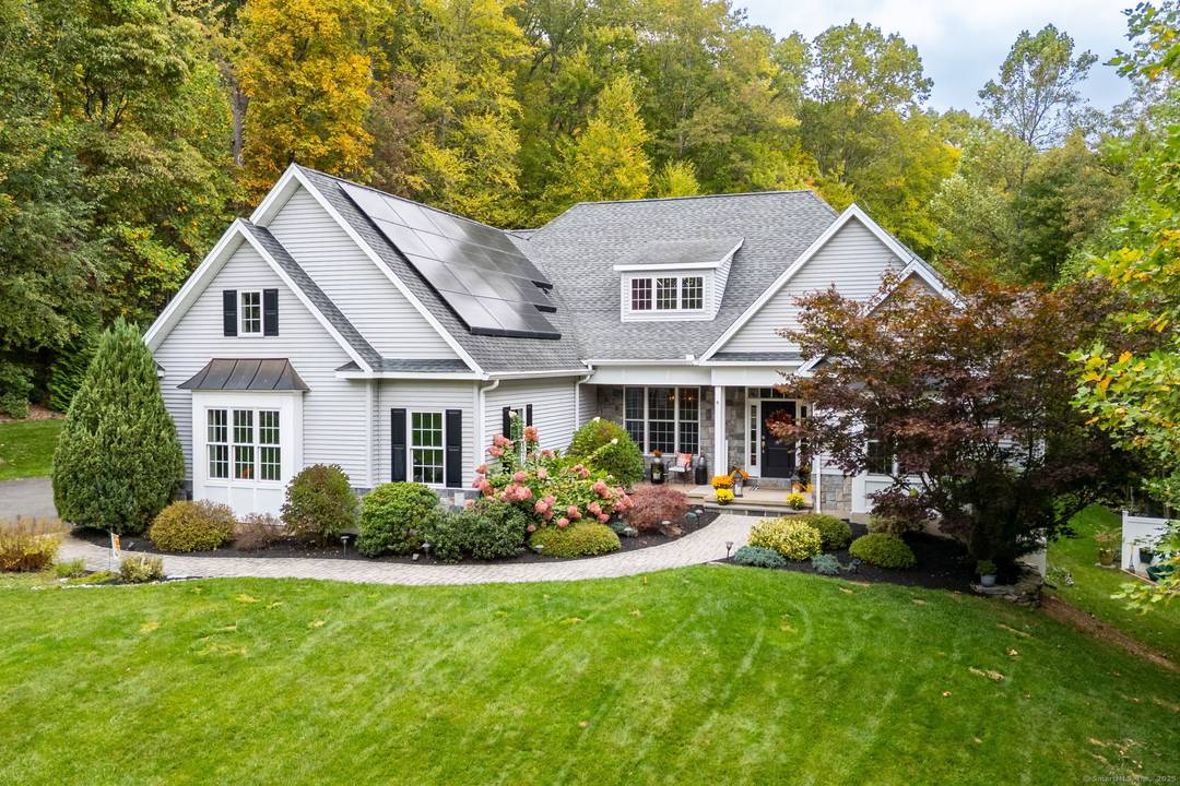 Welcome Home. Discover this beautifully designed Frank Betz residence, thoughtfully customized with a natural stone veneer facade and nestled amid serene, landscaped grounds.