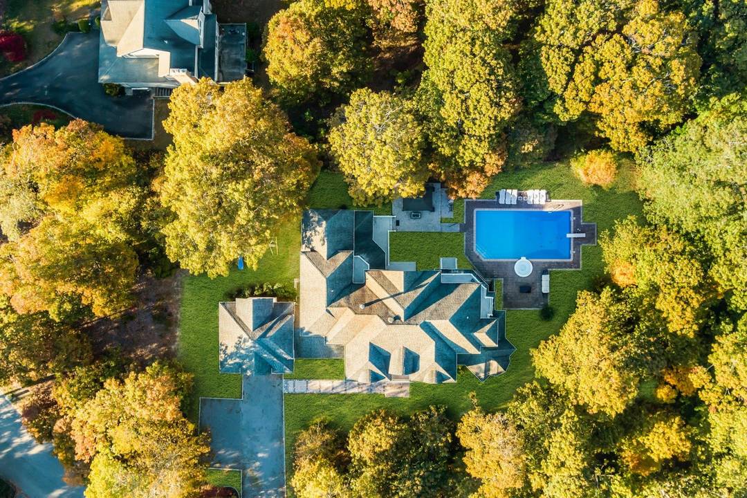 The open floor plan features a beautifully maintained interior that is awash with natural light and contains a formal dining room, large entertainment spaces, expansive great room, first floor bedroom, ...