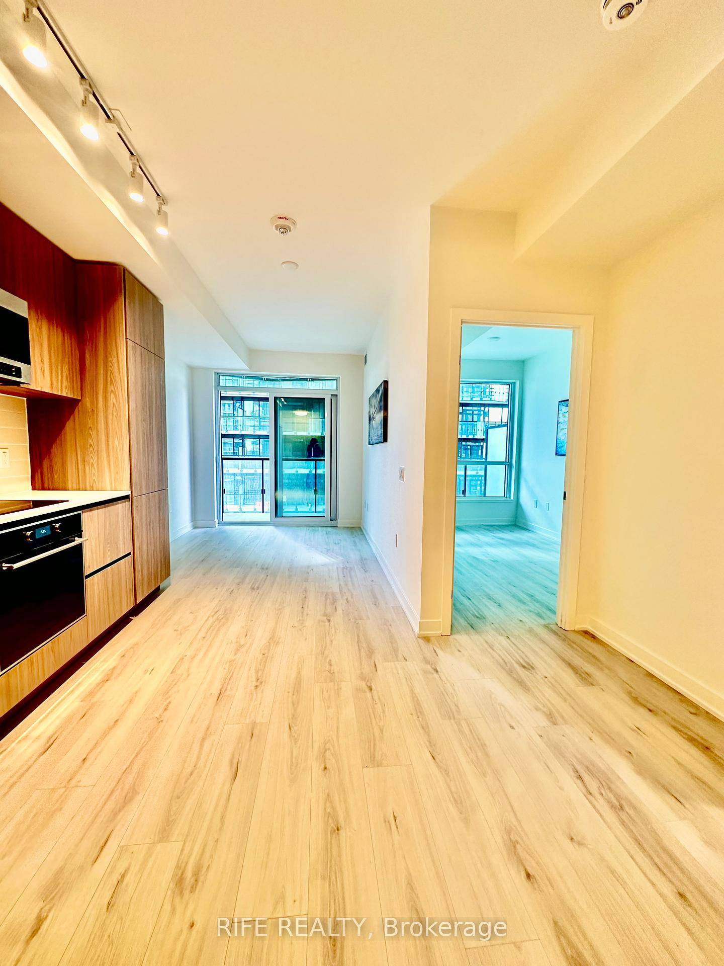 This stunning brand new 1 bedroom suite features a spacious bedroom with a large window, bringing in abundant natural light and creating a bright, airy atmosphere.