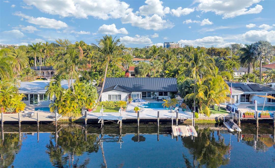 WOW FACTOR ! This Mid Century masterpiece by Michael Gruber Designs is a waterfront dream in Wilton Manors.