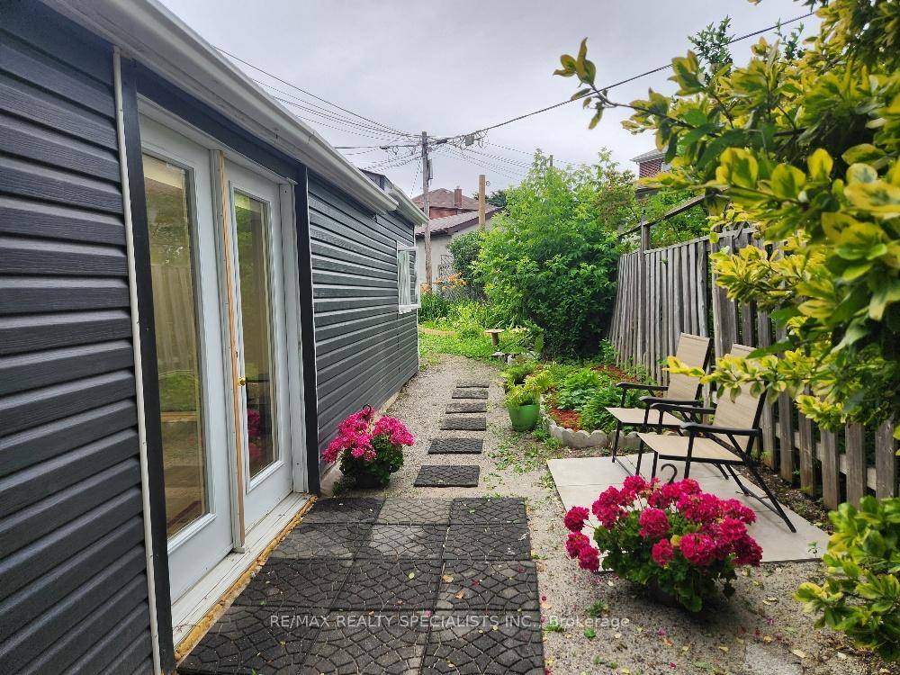 Fully detached garden apartment with separate entrance behind main house.