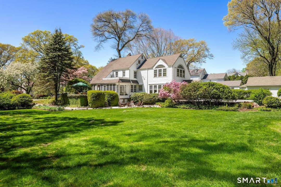 This storybook charmer sits on a rare half acre of flat, dry land directly abutting Woodland Park, creating a setting that feels both private and enchanting.