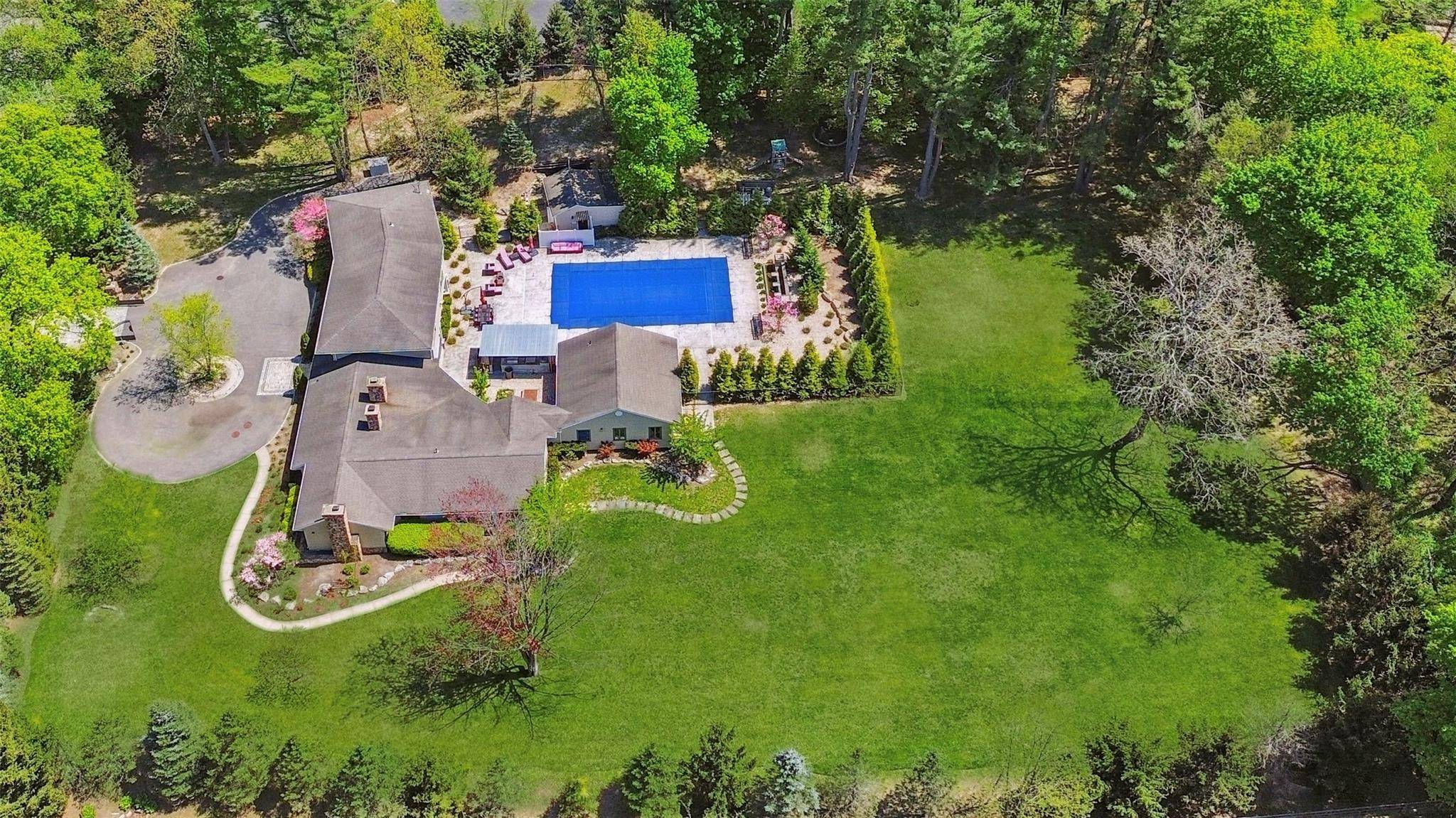 Tucked away on a fully fenced, over two acre, park like, electronic gated property, stands a sprawling Farm Rach expanded and remodeled in 2007.