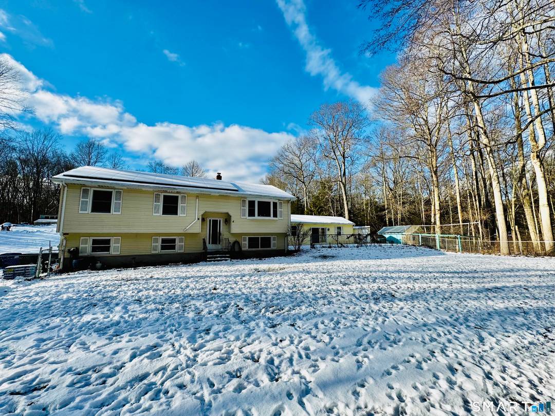 Welcome to this well maintained raised ranch, privately set back on a wooded lot in Ledyard, offering a peaceful and private setting with a thoughtfully designed, flexible layout.