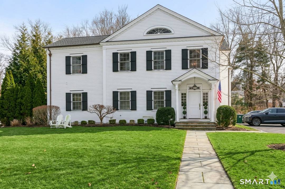 Enjoy stylish and easy living in this spectacular townhome on Southport's storybook Spruce Street.