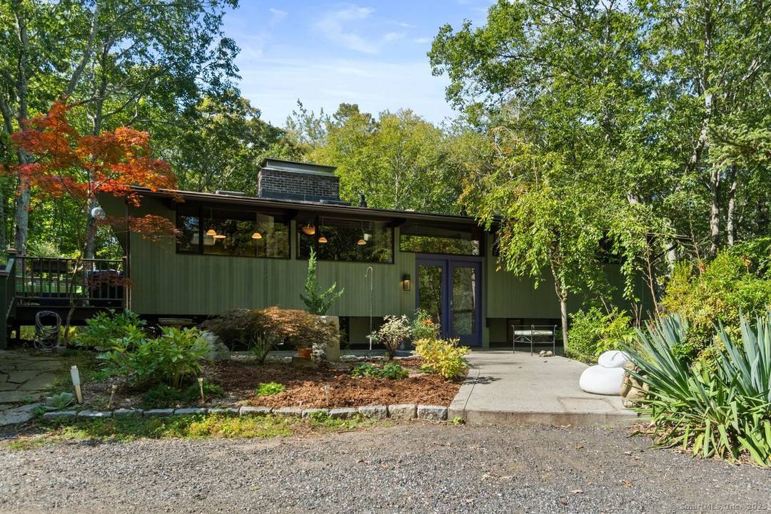 Set on 2 private acres in scenic East Haddam, this custom Acorn Deck Home offers a peaceful retreat surrounded by native gardens and a tranquil water feature.