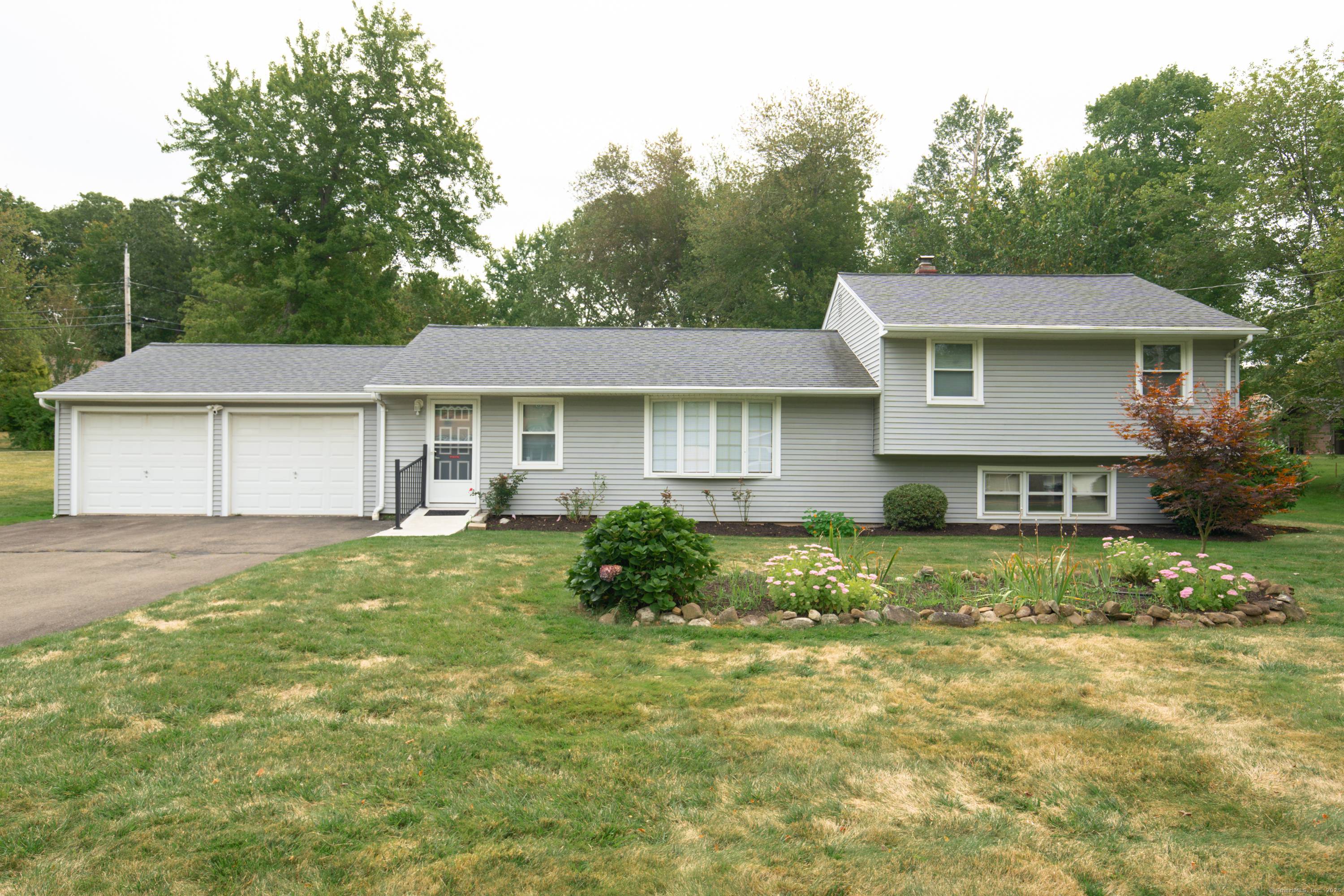 Welcome to this corner lot home with multiple living areas and a large, manicured yard.