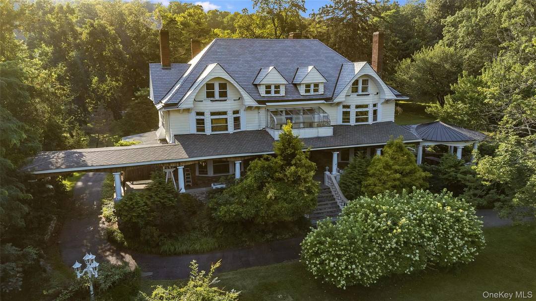 Evoking the charms of a more serene life, this Victorian center hall mansion, set on 5.