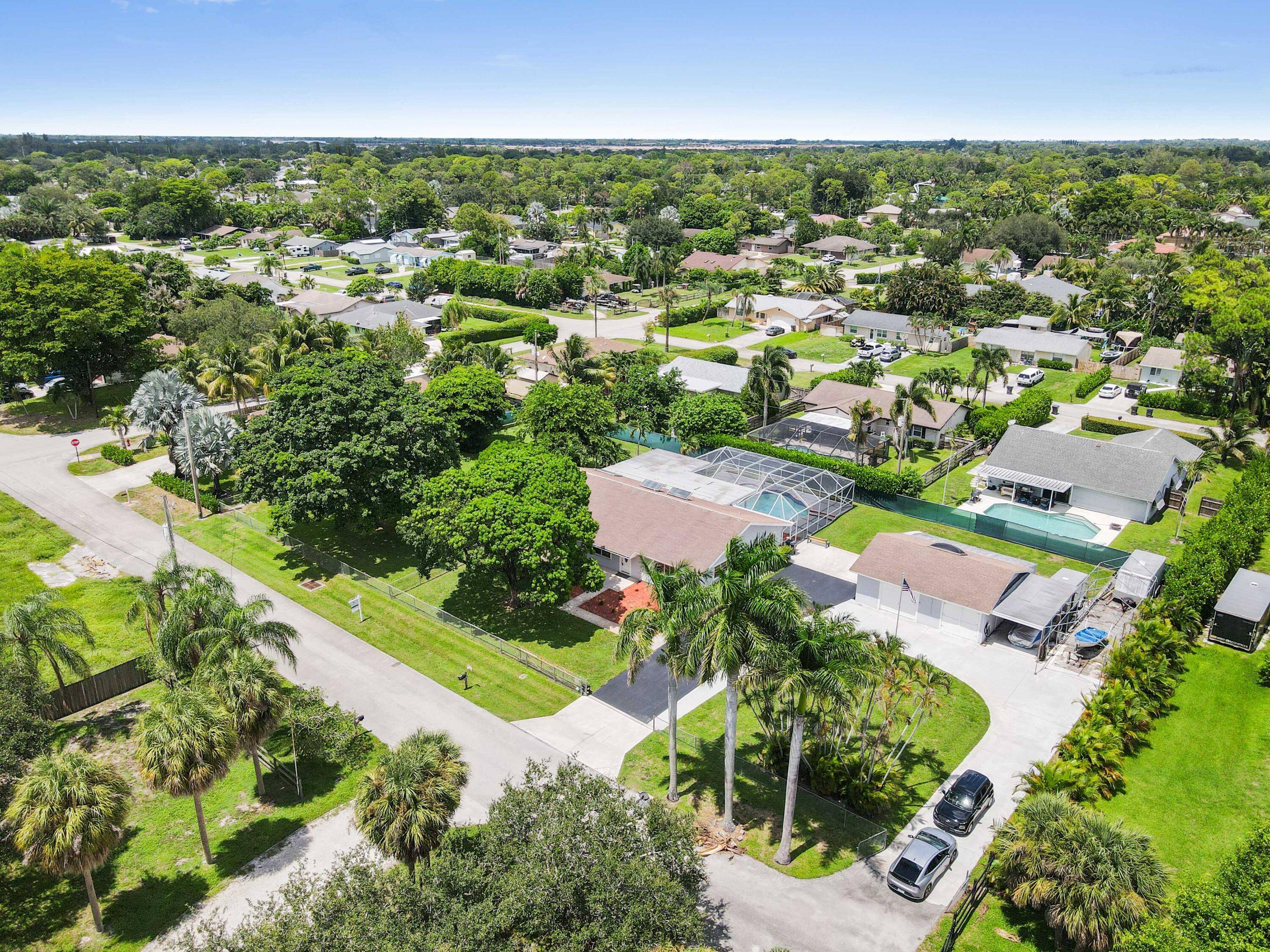 Located in the desirable community of Palm Beach Farms, this spacious pool home sits on over 1 2 acre with no HOA.