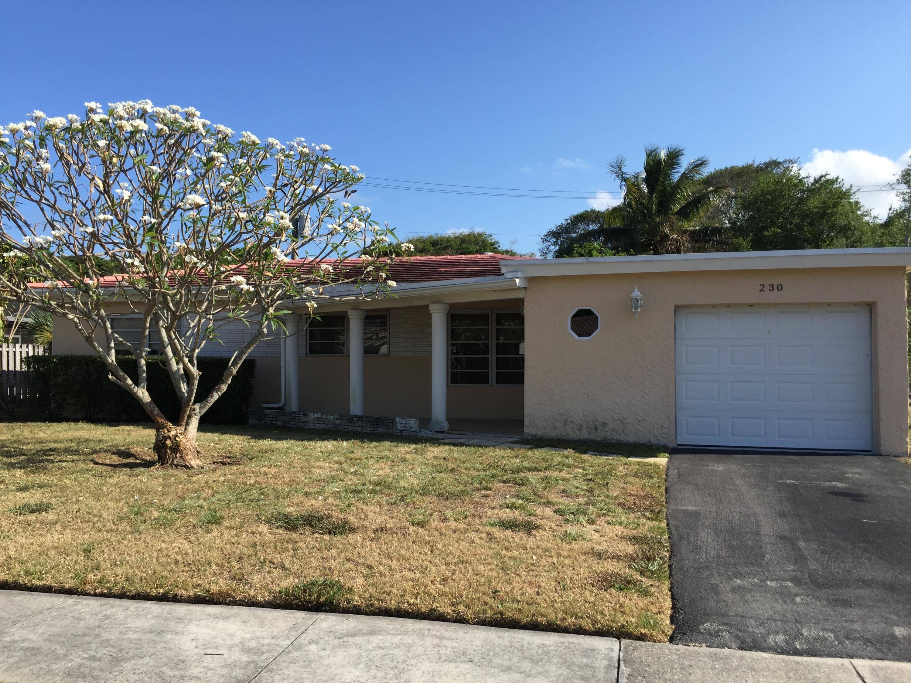 Investor Special ! 4 Bedroom 2 Bath home with a garage and covered patio in East Boca Raton.