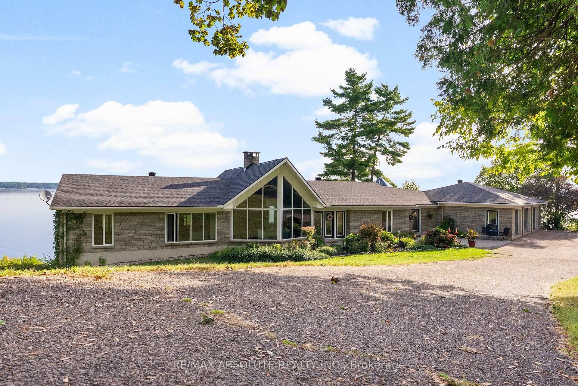 Panoramic views of the Ottawa River from this stunning custom built bungalow !