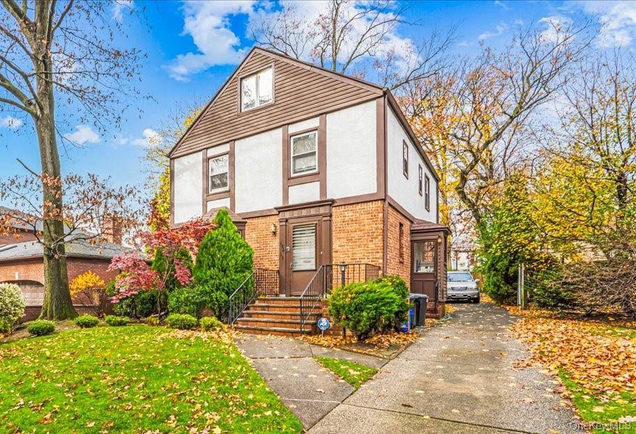 Step into this charming Brick Tudor Colonial in Jamaica Estates, where gleaming hardwood floors flow throughout the entire house.
