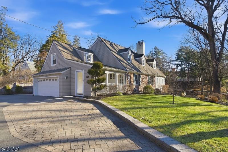 Perched on a hill along New Providence Road, this two story ranch offers strong curb appeal, visibility, and a spacious property in desirable Mountainside.