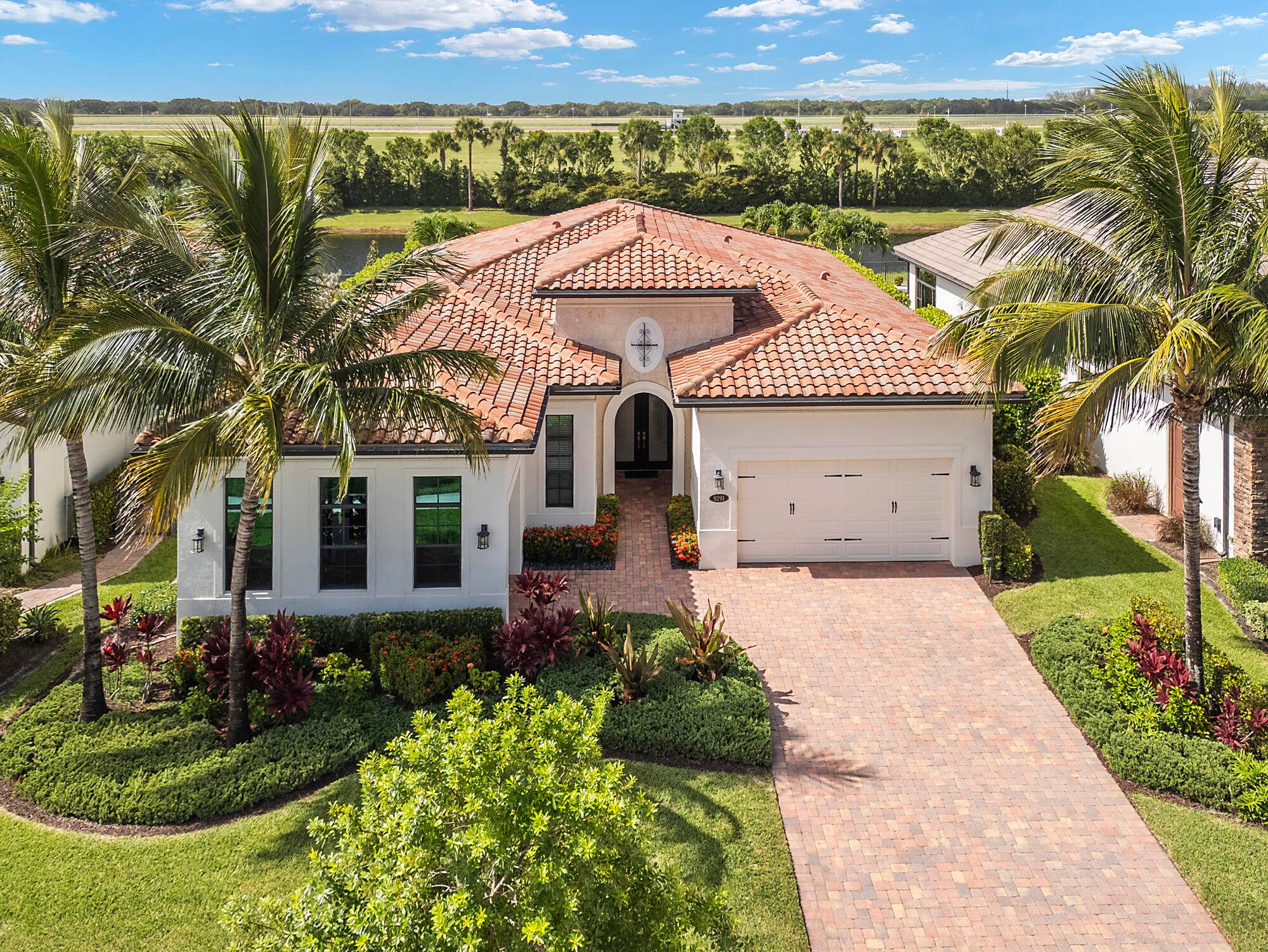 Step into unparalleled luxury in this stunning single story estate nestled within the exclusive guard gated Palm Meadows Estates.