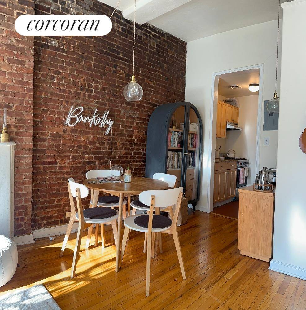 South facing one bedroom with pre war details such as exposed brick, hardwood floors and decorative fireplace.