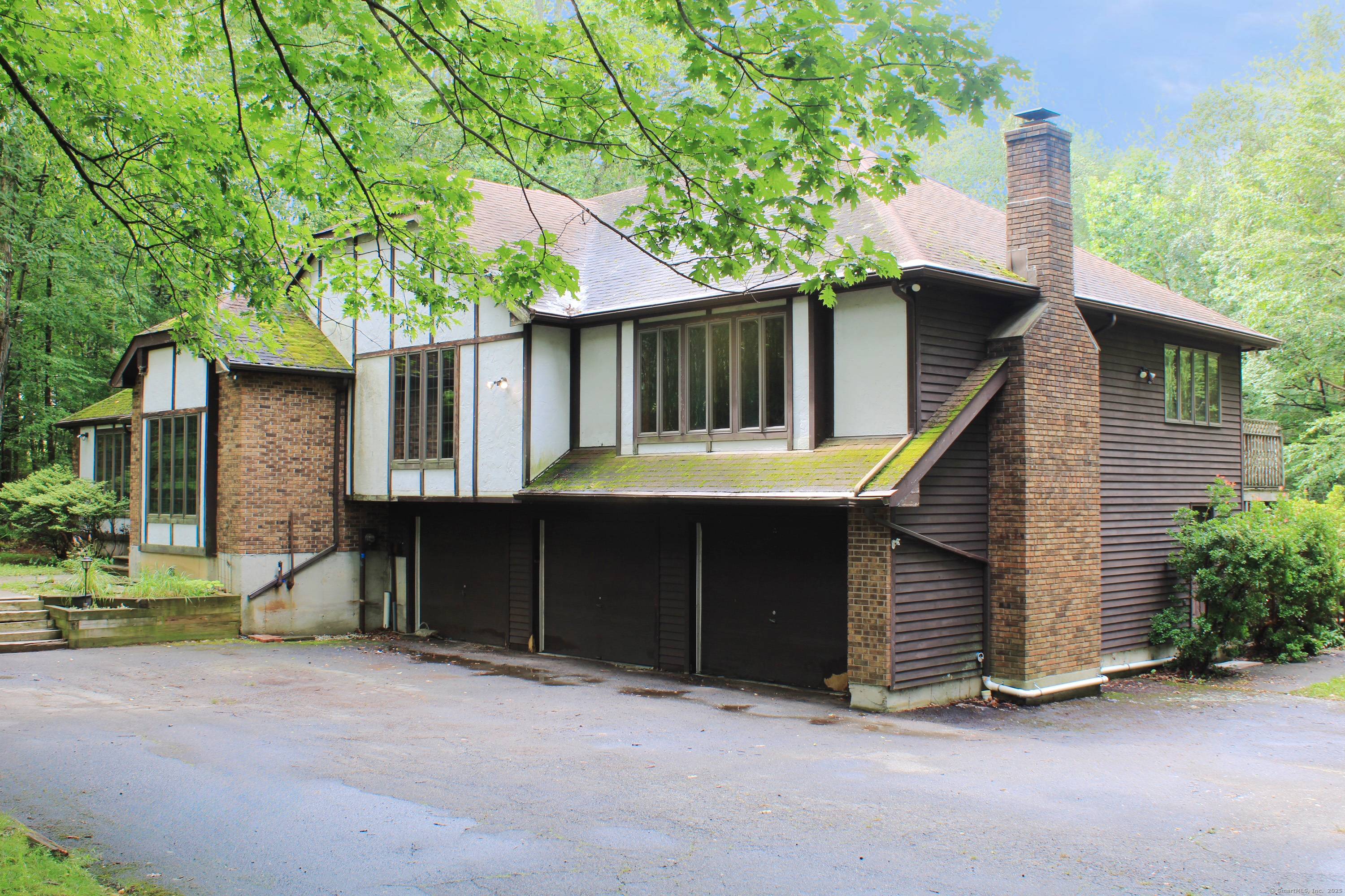 Private wooded setting, multi level Tudor Style home on 2.