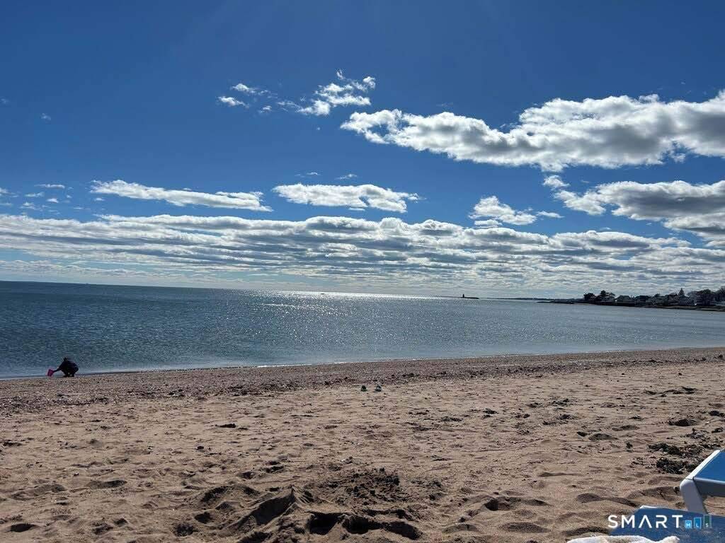 92 Caroline Road in East Haven is a charming 624 square foot, two bedroom summer cottage set directly on a private white sandy beach along Long Island Sound.
