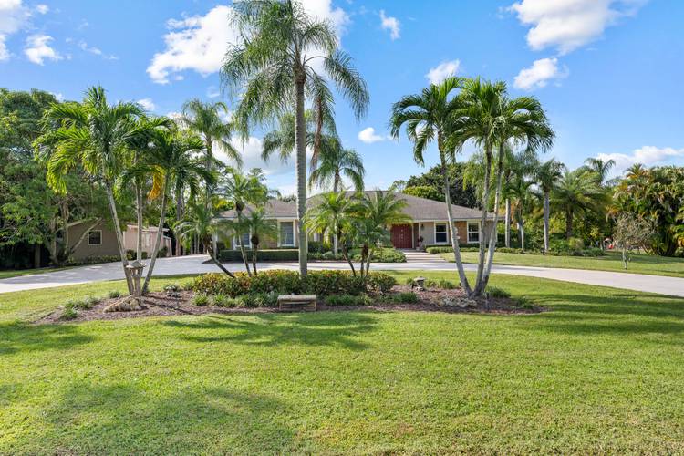 Set on 1. 15 acres in Palm Beach Country Estates, this beautifully upgraded 4BR 3BA home offers privacy, space, and modern efficiency with no HOA.