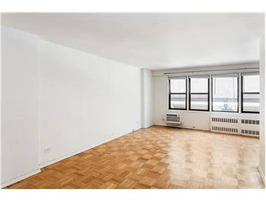 Large, light filled alcove studio benefits from a wall of windows and is very sunny and quiet.