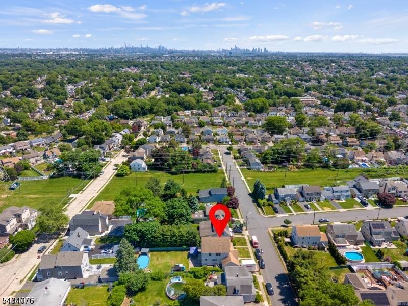 Located on a quiet residential street with views of the NYC skyline in the distance, this spacious home offers exceptional living space both inside and out.