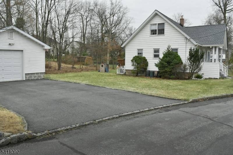 Welcome to this well maintained inviting Cape Cod style home complete with a new roof gutters 2025, a welcoming Lemonade Porch and a large Detached Over Sized Garage w repaved ...