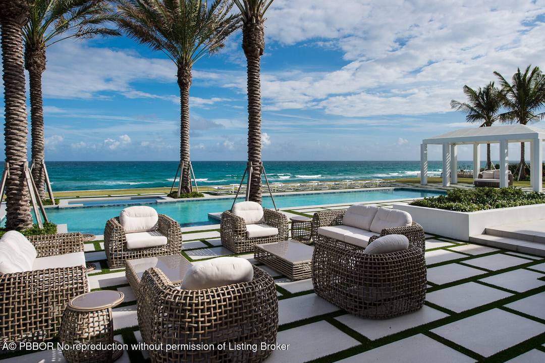 Stunning Ocean to Lake estate set on an oversized, premier Manalapan lot with 150 feet of direct ocean frontage.