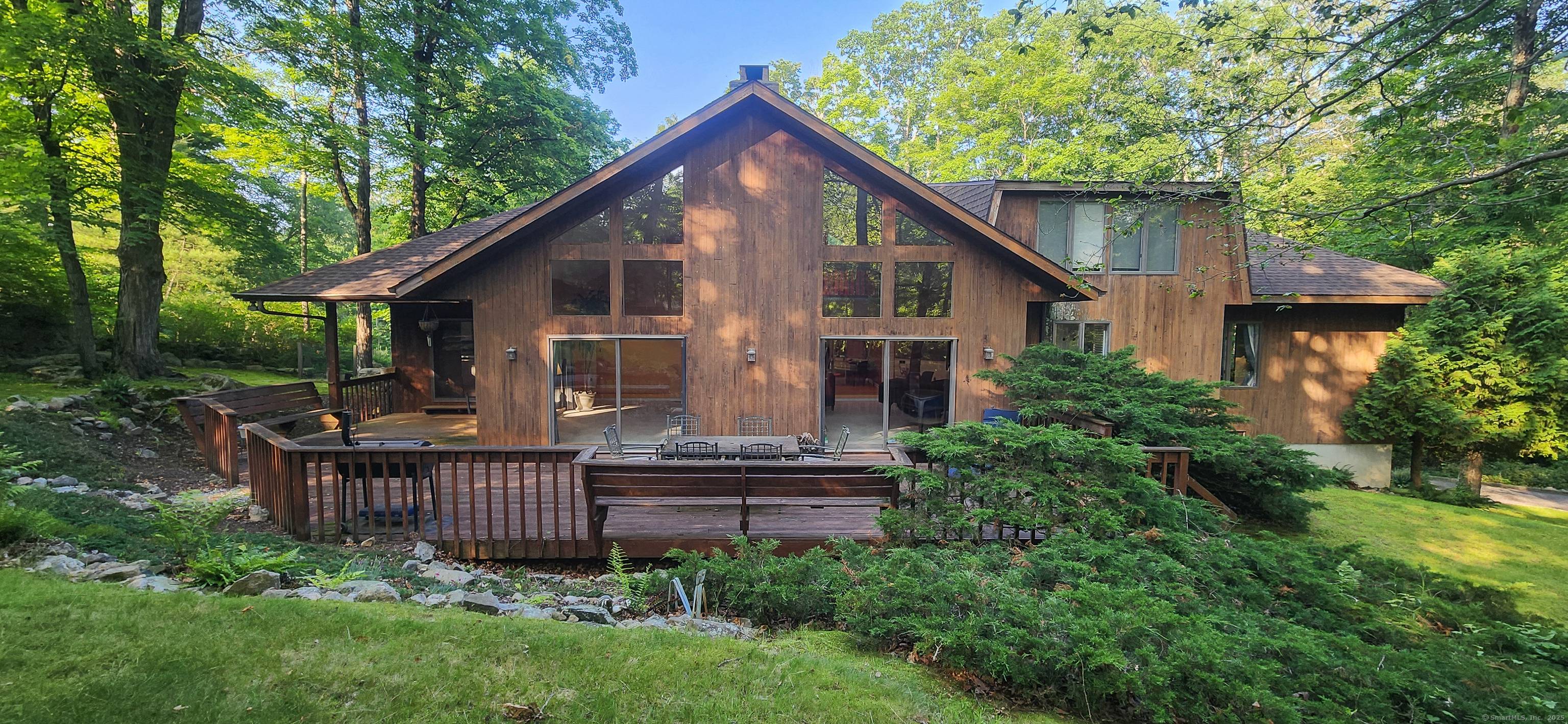 Set atop a long, private drive, this stunning contemporary home offers tranquility in bucolic North Stamford.