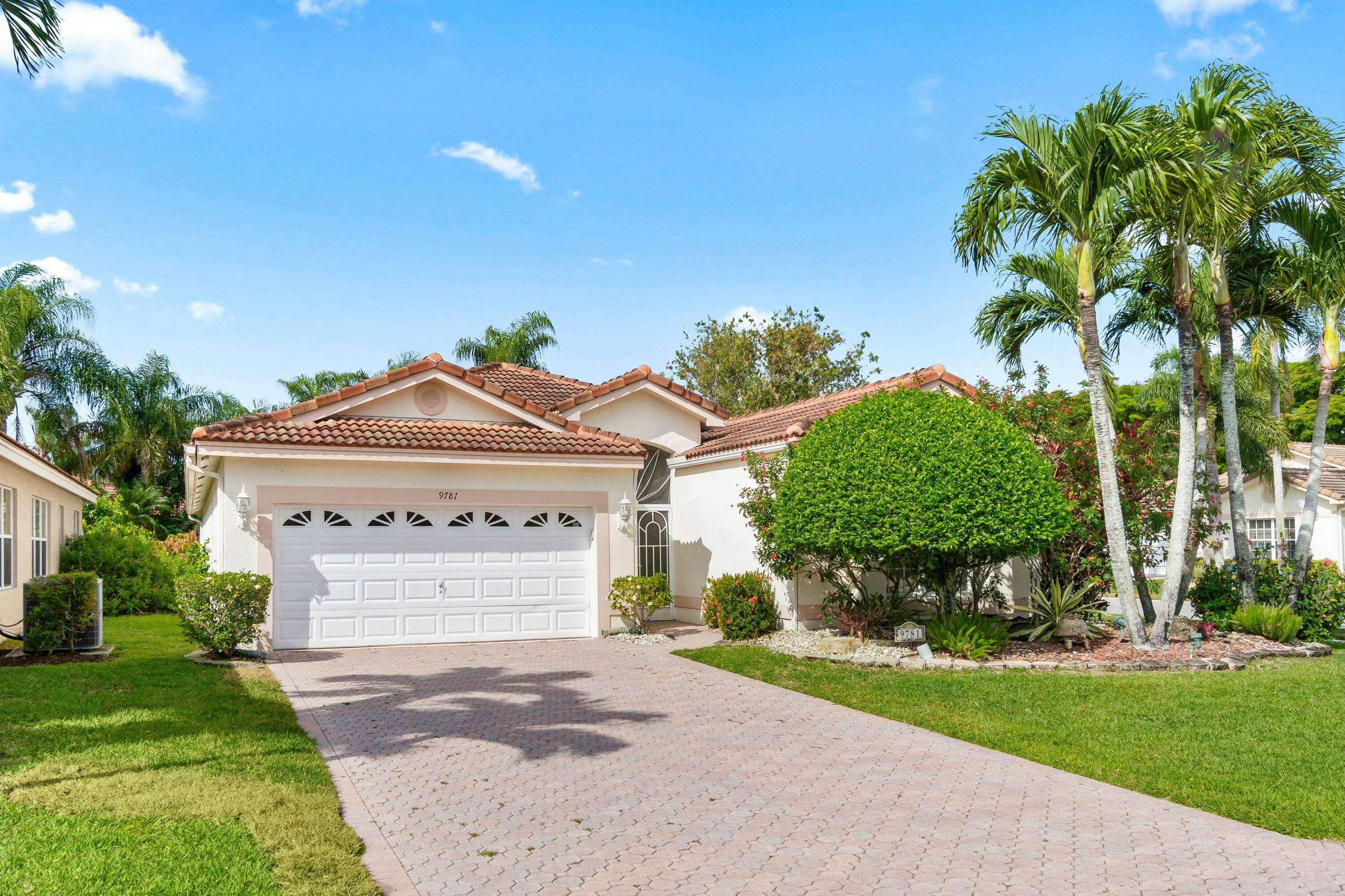 LOW HOA, newer Roof AC, this oversize corner lot offers an enclosed lanai with mini split for year round comfort and views of mature, tropical landscaping.