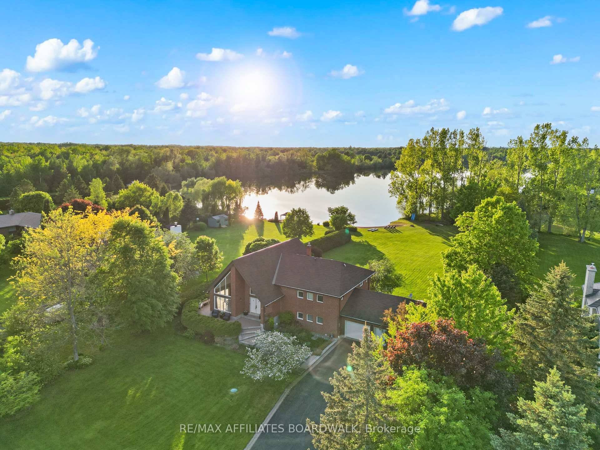 Tucked away in the exclusive community of Lakeland Estates, this custom waterfront retreat offers 1.