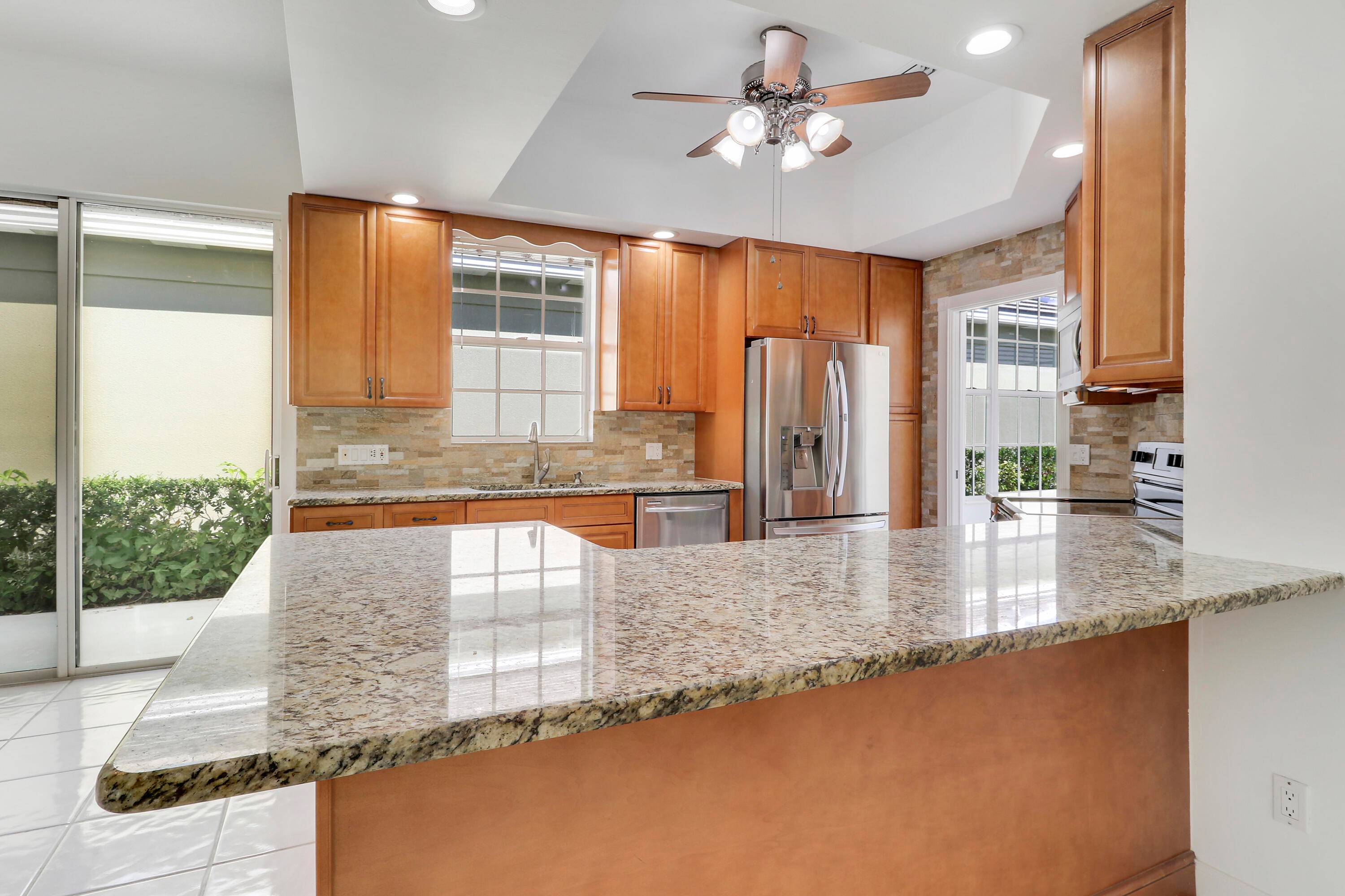 Light, bright, and move in ready, this immaculate home offers a spacious split floor plan with vaulted ceilings and a dedicated study area.