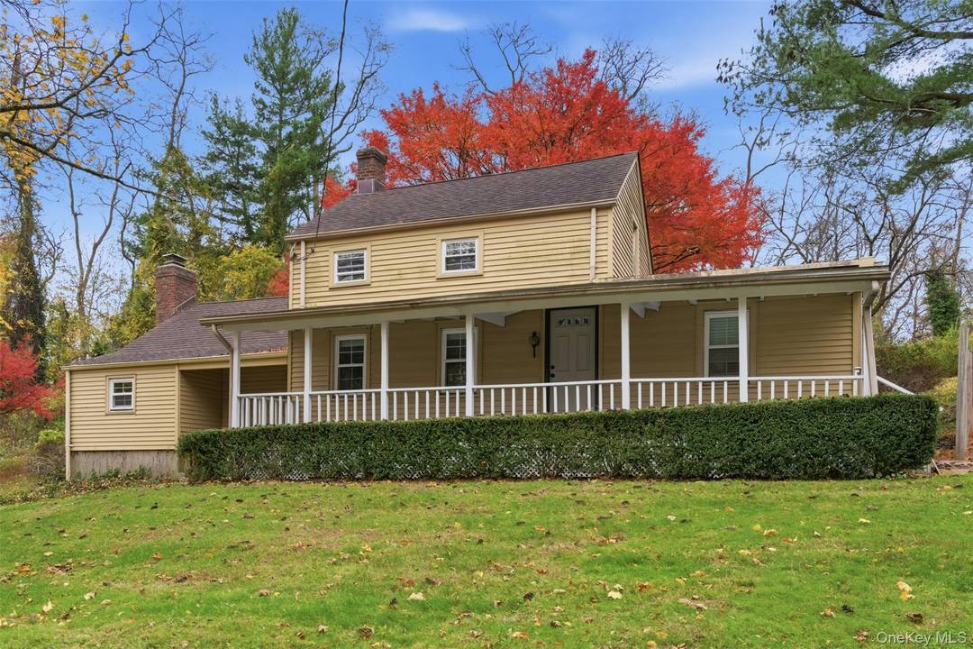 Discover storybook charm in this delightful Lloyd Harbor cottage, privately set back on 2.
