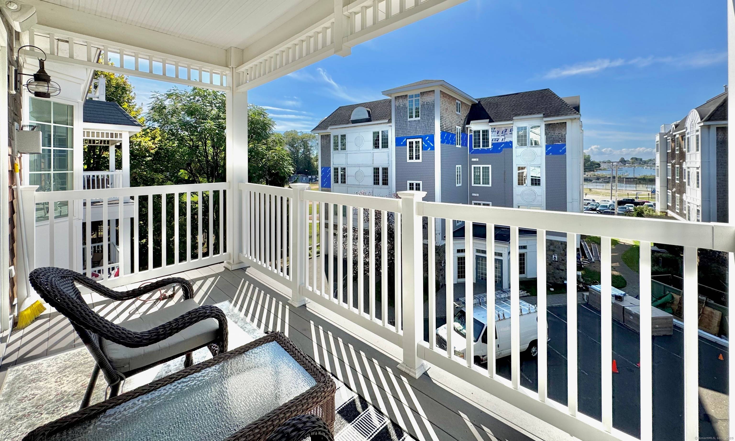 Welcome to this stunning ranch style end unit in a sought after gated community with elevator access and captivating views of Milford Harbor.