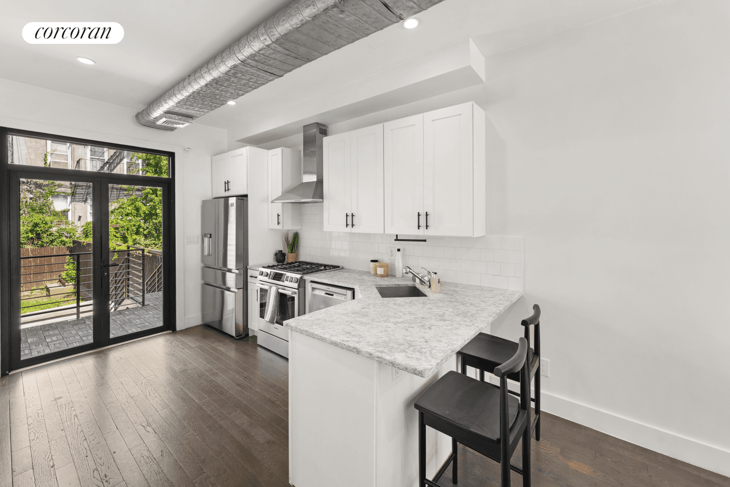 This beautifully renovated two family townhouse seamlessly blends modern design with a loft like ambiance.