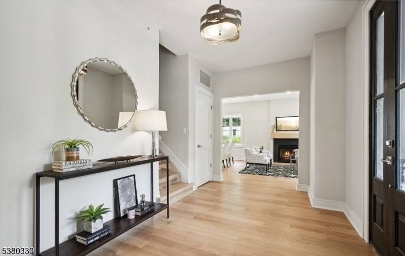 Beautifully designed custom townhouse showcasing an open floor plan with soaring ceilings, modern bathrooms, and gleaming oak hardwood floors throughout.