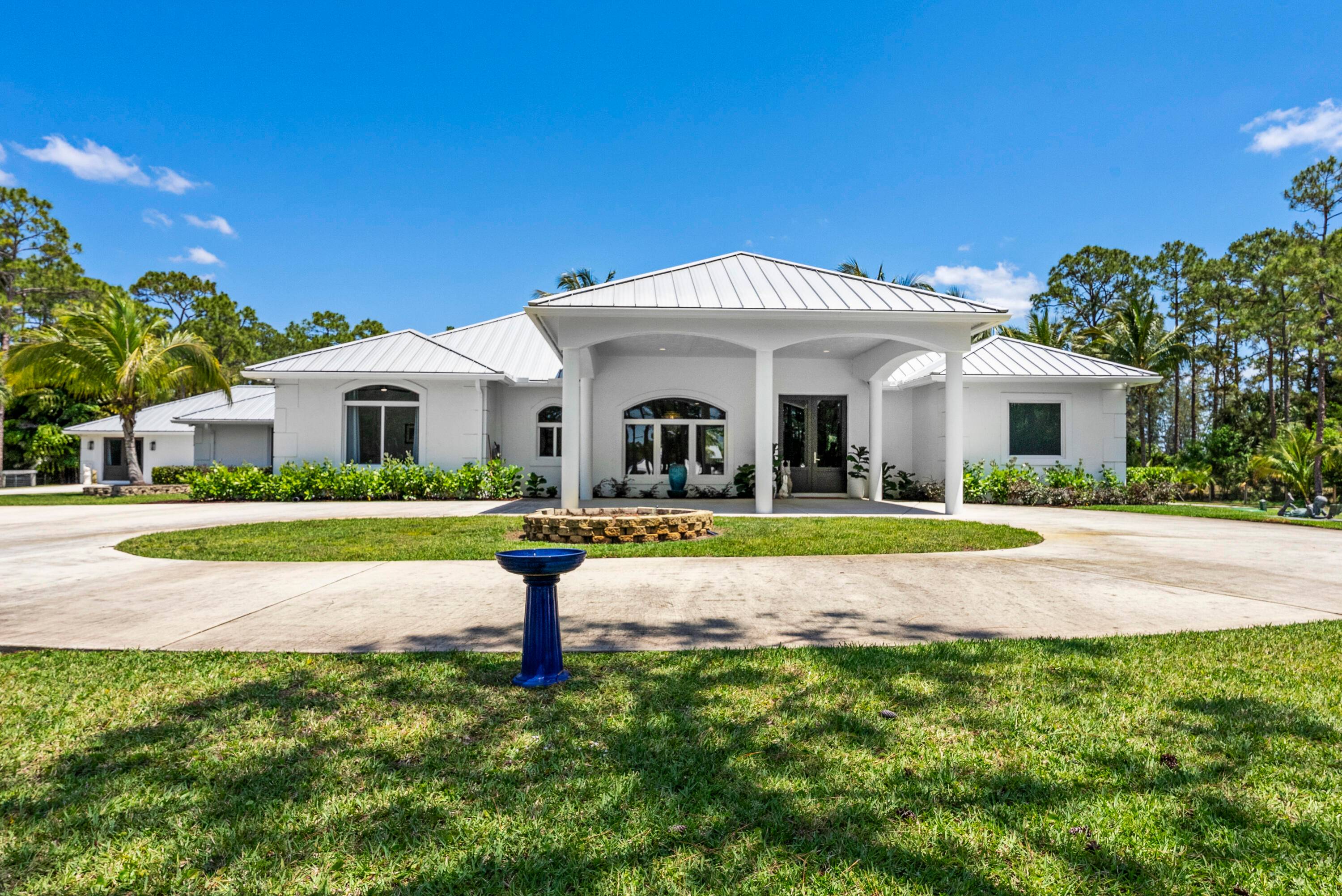 THIS EXCEPTIONAL ENCLAVE IS LOCATED IN TRANQUIL CALOOSA ENCOMPASSING 5 ACRES.