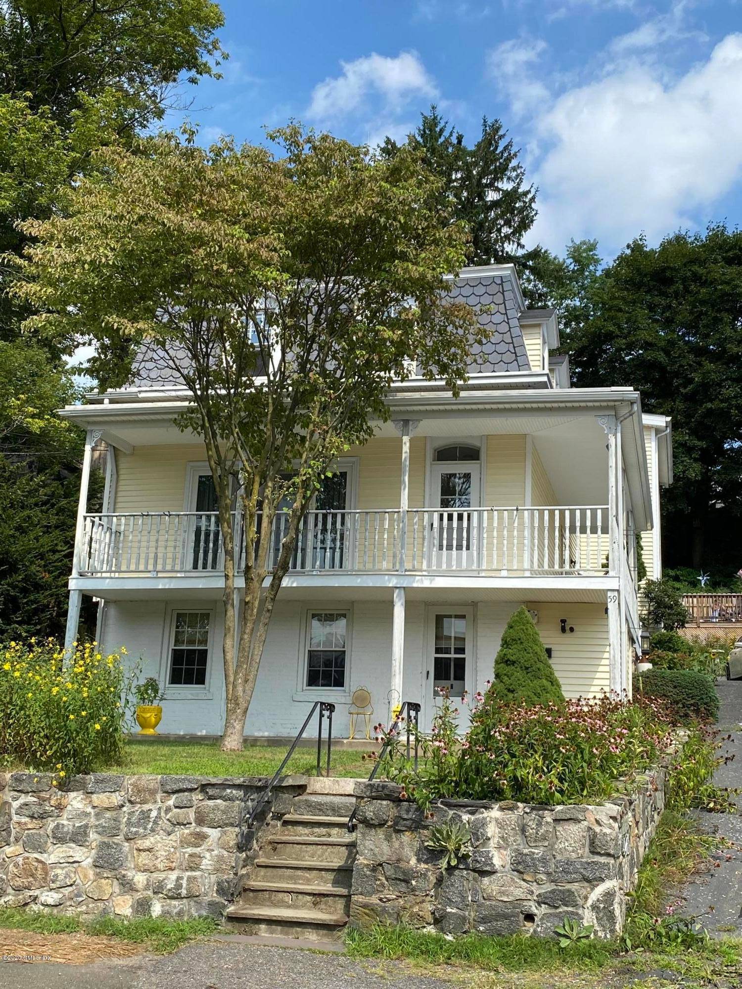 Fabulous gardens enhance the private patio and pool with deck of this updated Mansard roofed treasured home.