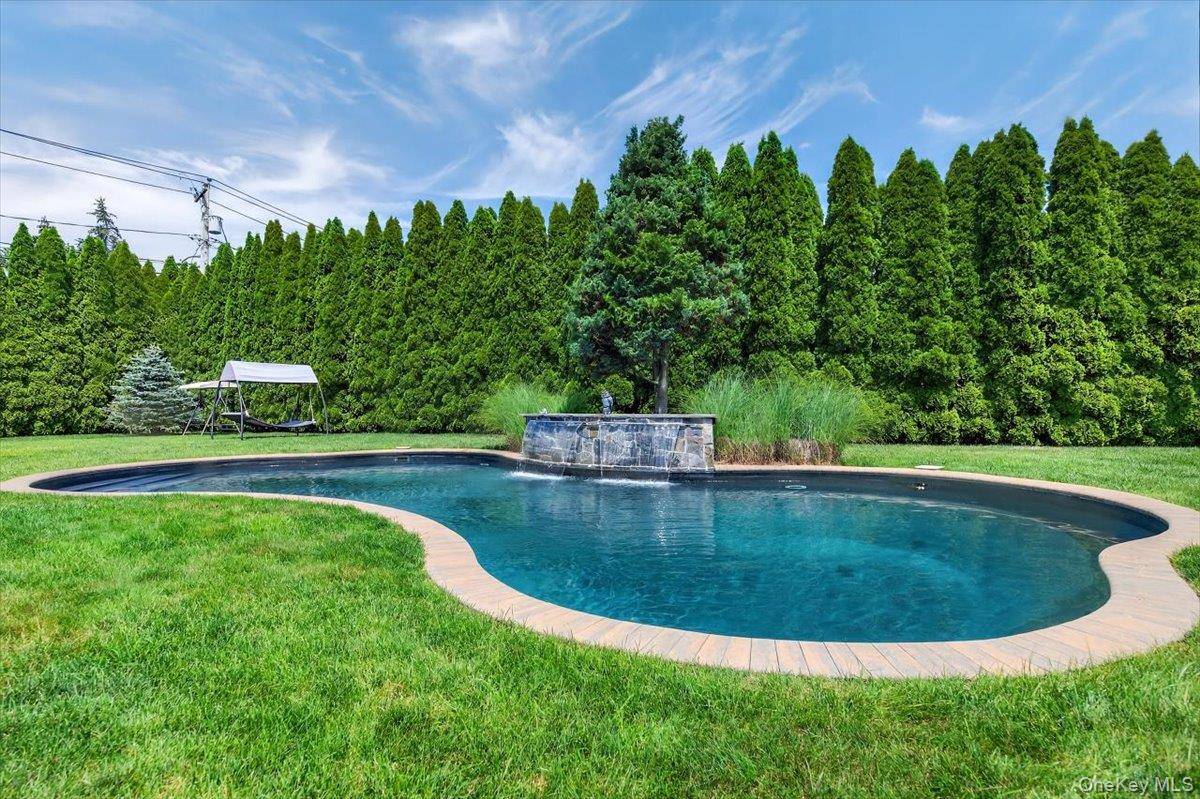 Welcome to 75 Head of the Neck Road in Bellport, a truly private and meticulously kept home.