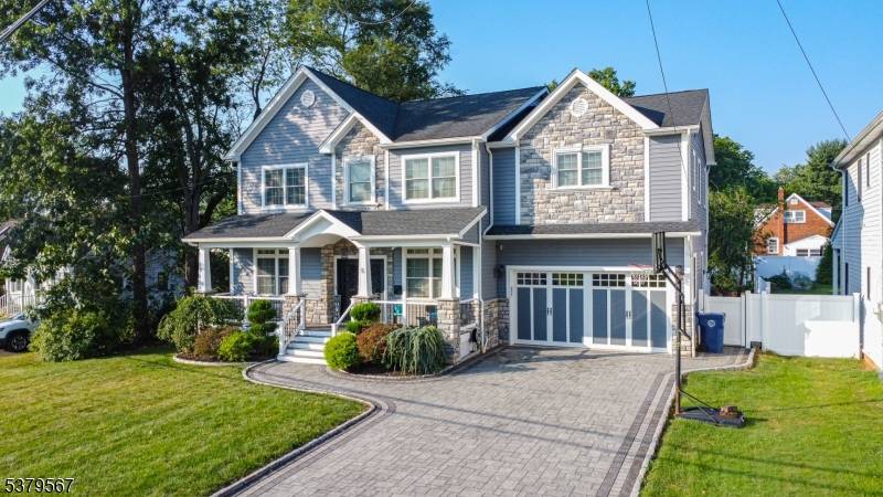 Custom built center hall colonial sitting on a large 66x160 lot features a Chefs kitchen with custom cabinets, 6 burner Jenn Air Stove, center Island and a walk in pantry.