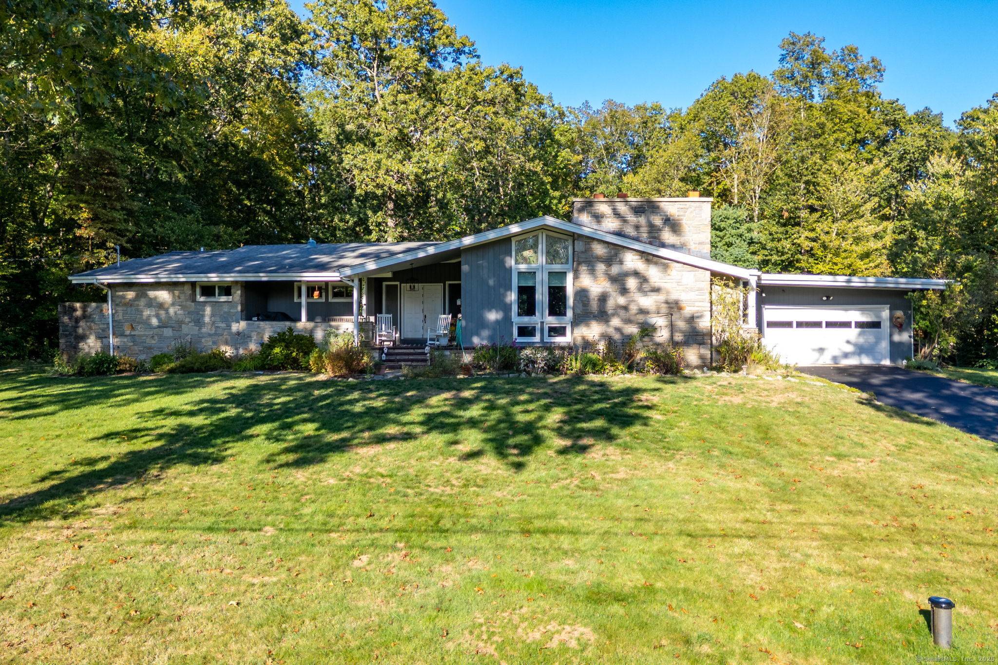 Distinctive Contemporary Ranch set on a peaceful cul de sac with lush plantings.