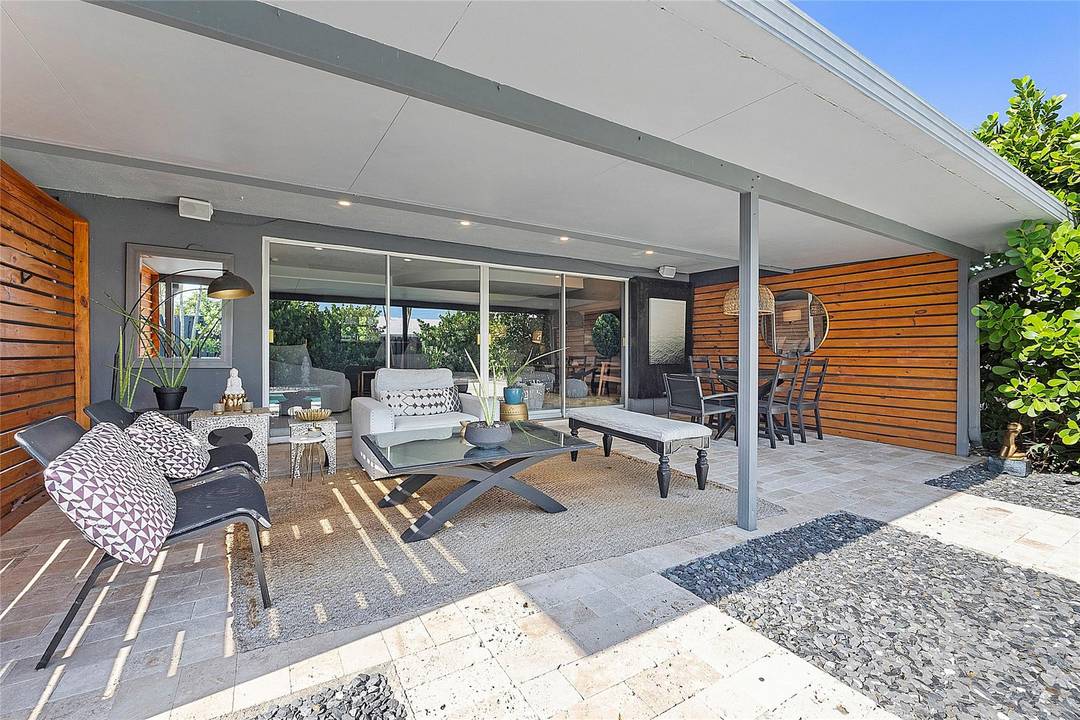 This stunning residence offers a heated sports pool designed for lap swimming and volleyball, surrounded by multiple lounging areas, including a pergola with TV perfect for relaxing and enjoying the ...