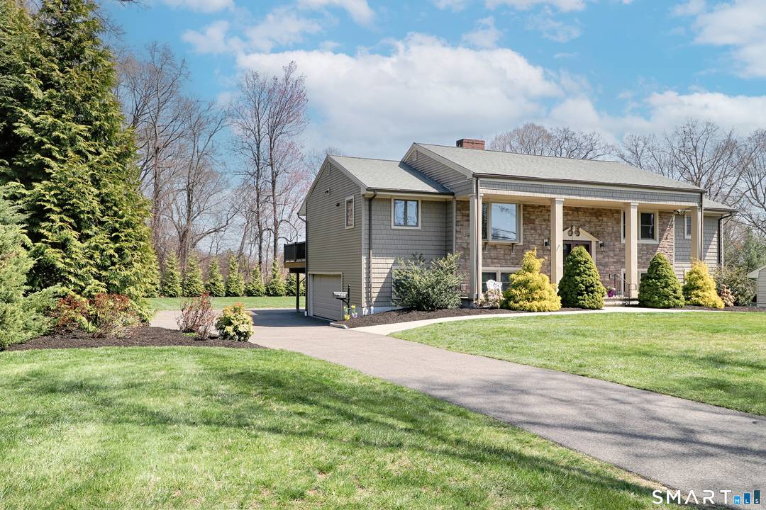 An amazing raised ranch set beautifully on a landscaped half acre.