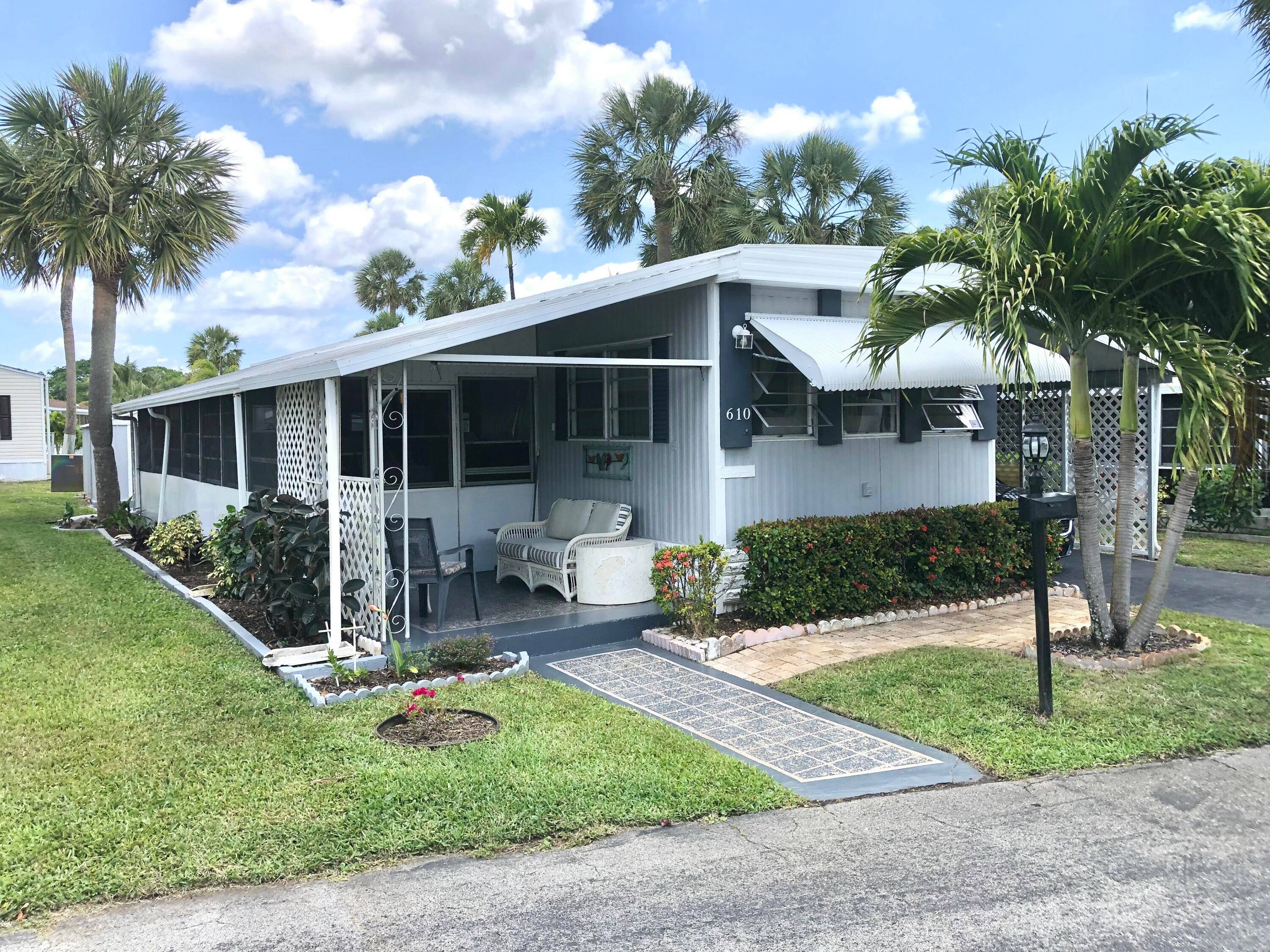 Charming residence located on a quiet street, featuring 2 bathrooms, 2 bedrooms, a Florida room, and a sunny outdoor space.