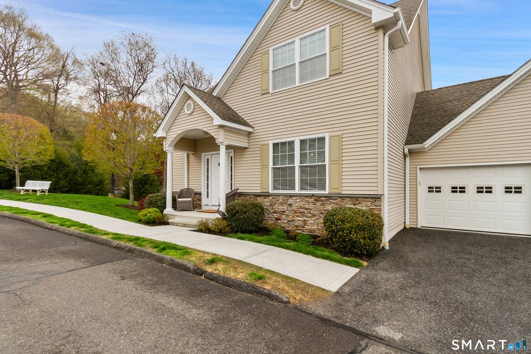 Immaculate and beautifully designed end unit in sought after Dunham Pond active adult community !