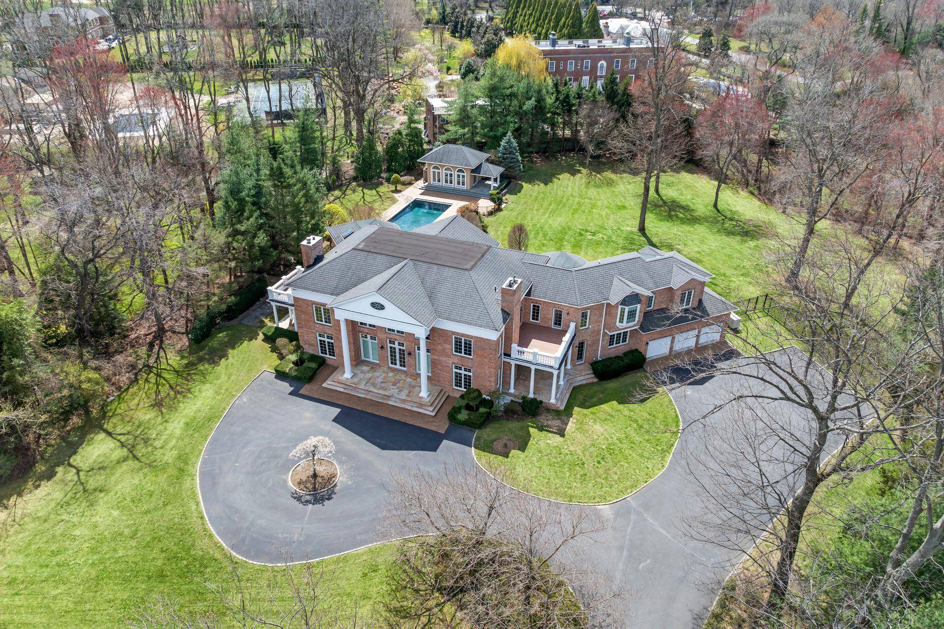 Nestled in the prestigious Harriman Estates of Sands Point, this all brick colonial masterpiece spans 2.