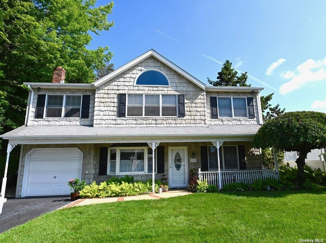 Move into this bright and sunny spacious colonial home on quiet tree lined residential street.